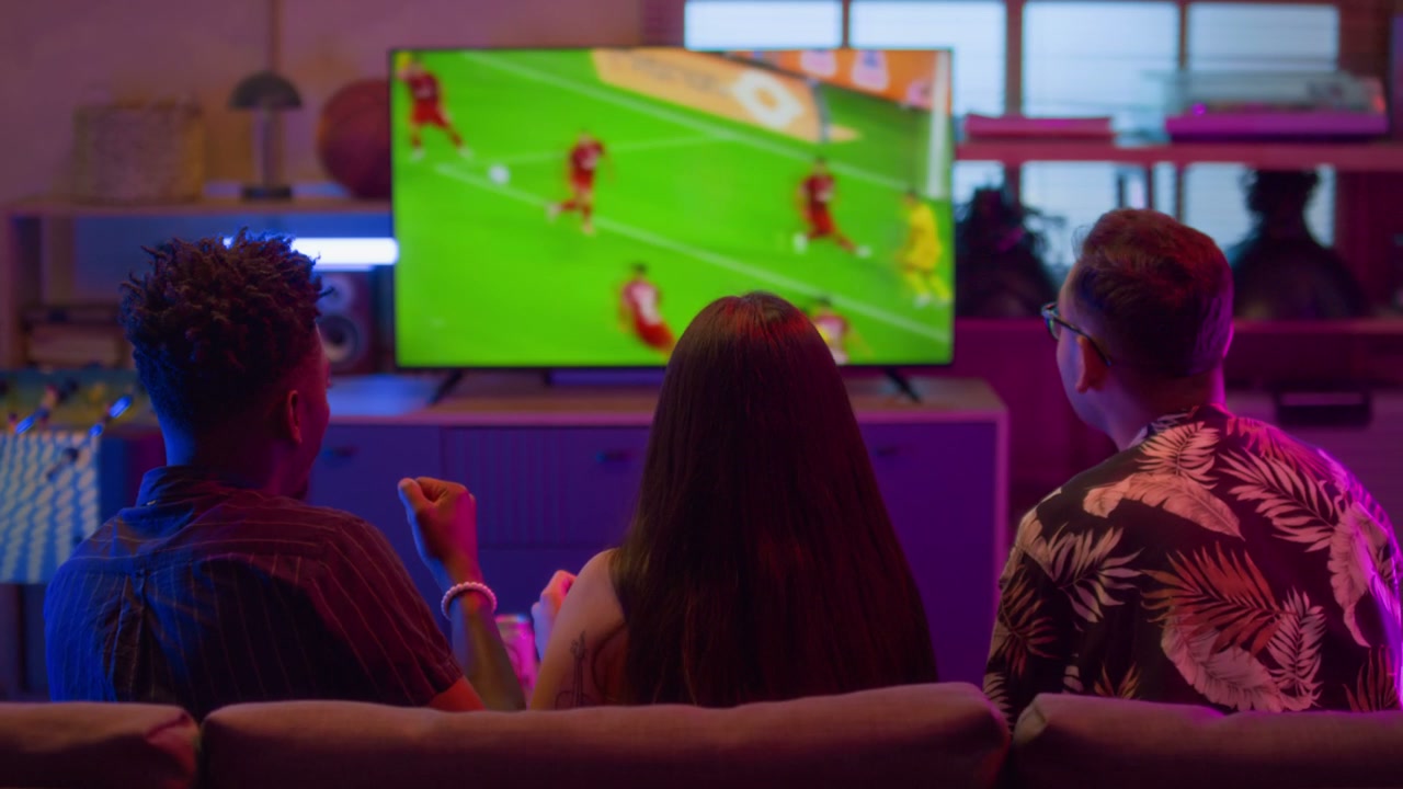 Friends Celebrating Football Goal on Television