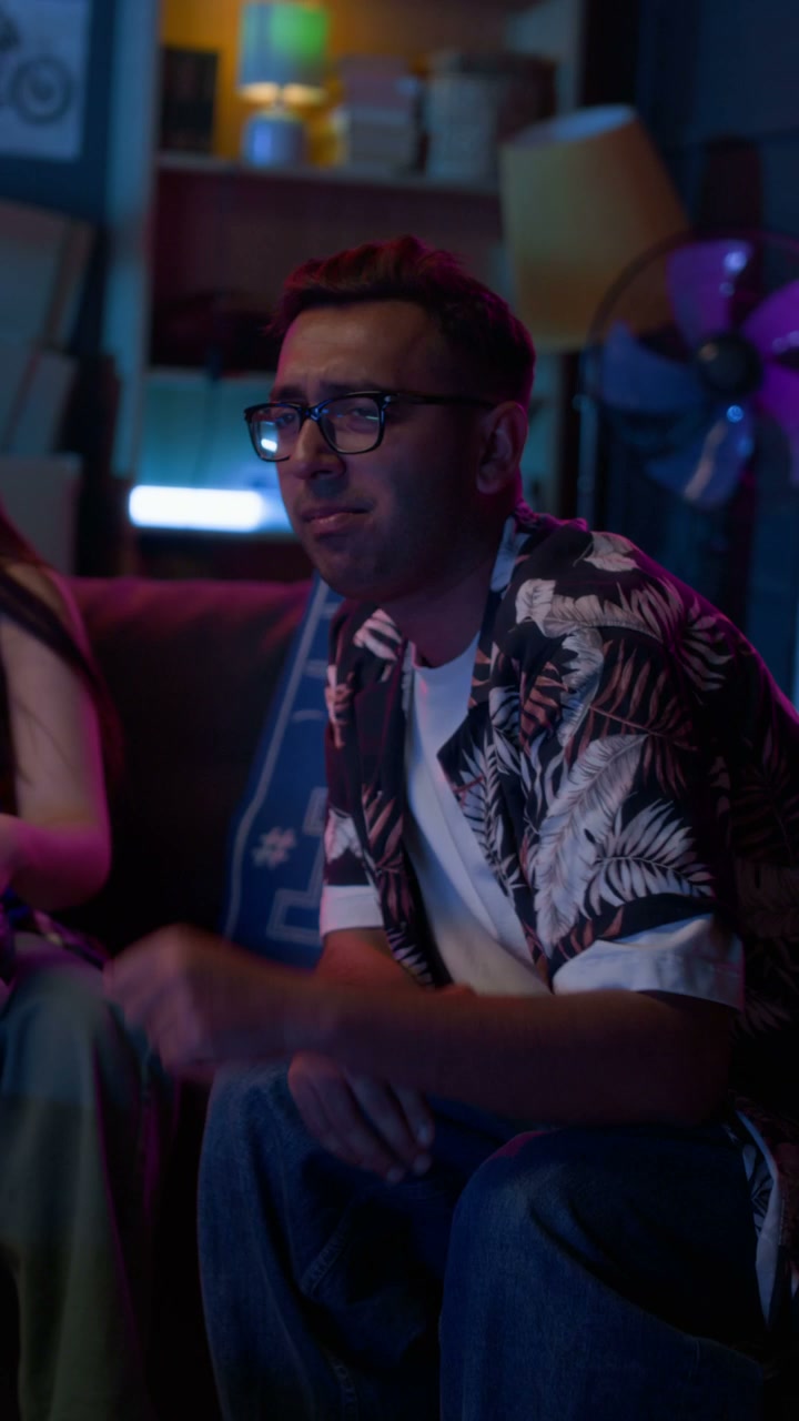 Young Man Watching Sports Game at Home