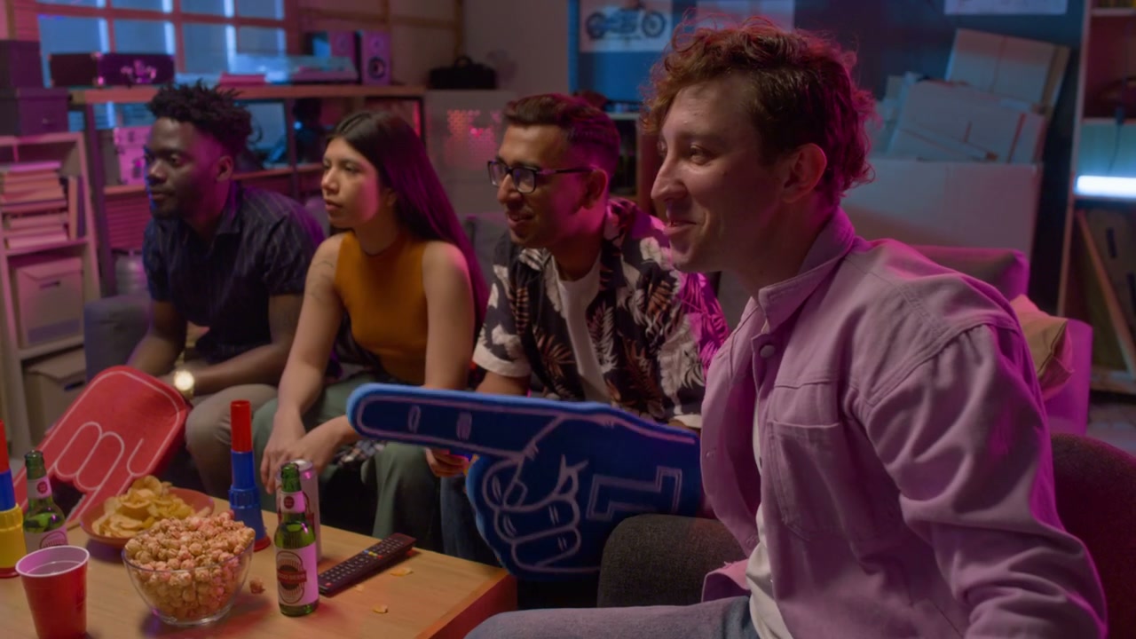 Group of Friends Watching Sports with Foam Fingers