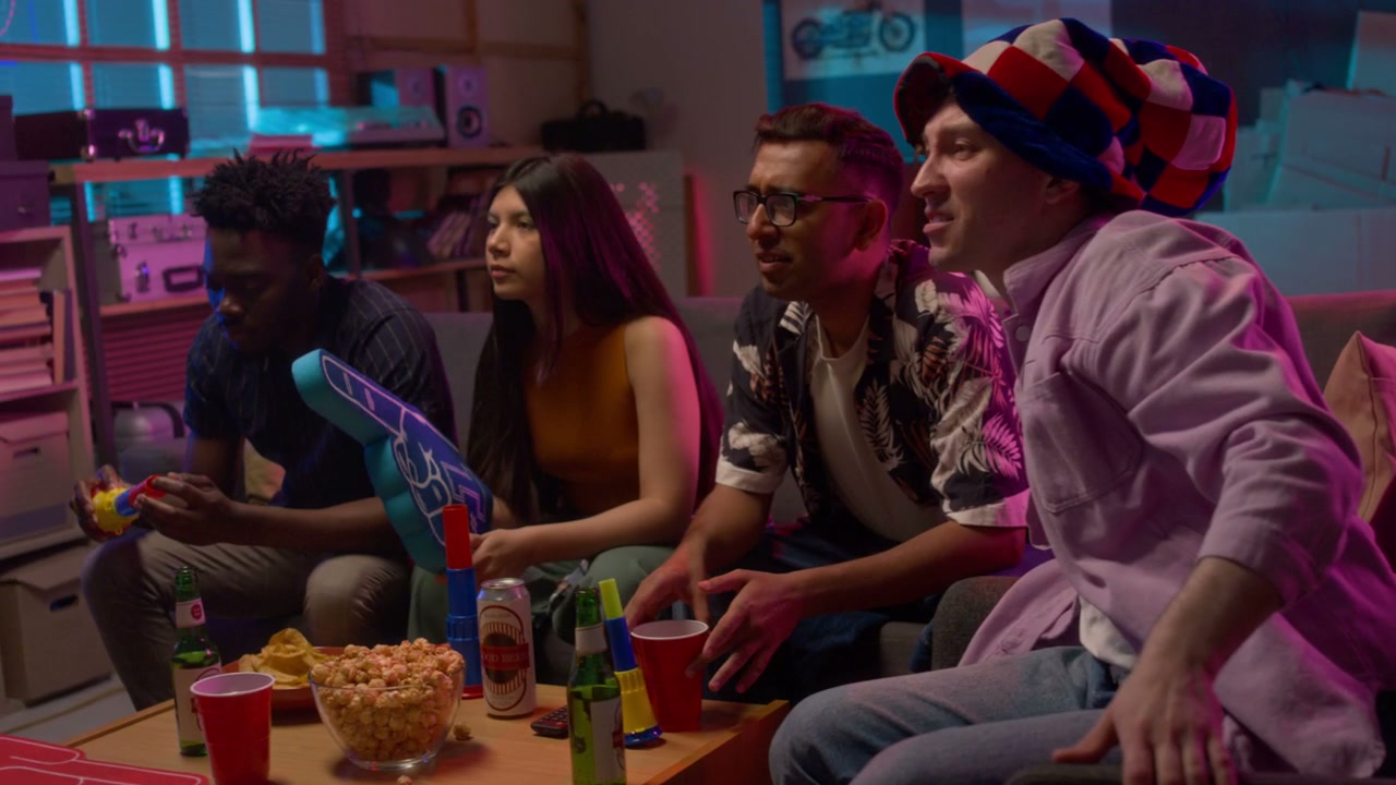 Friends Cheering for Sports Team at Night
