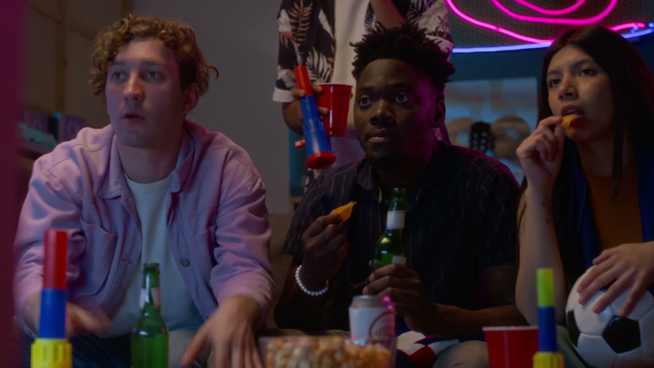 Diverse Group Watches Sports Game at Home