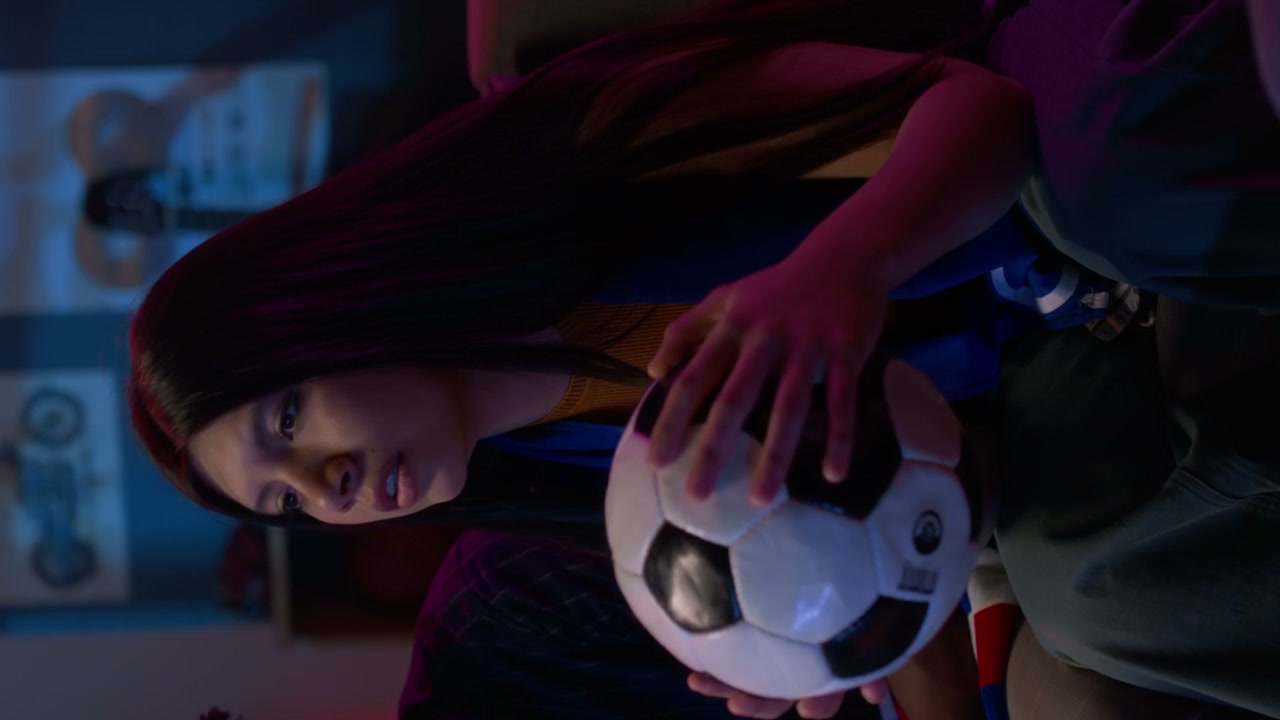 Young Woman Watching Football Game at Home