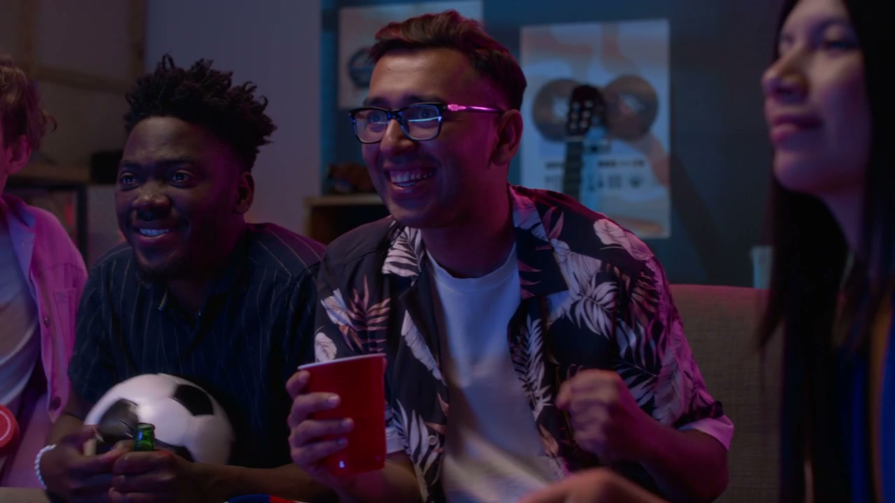 Friends Cheering While Watching Sports Game