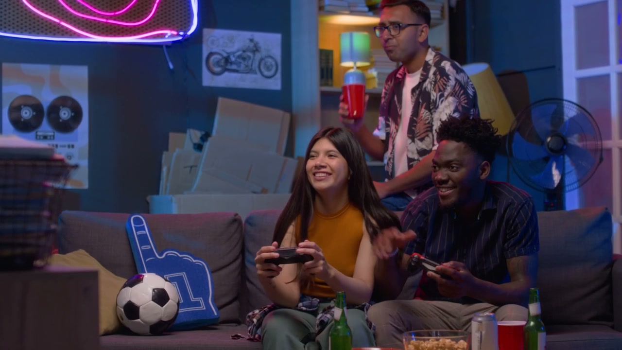 Diverse Friends Playing Video Games at Night