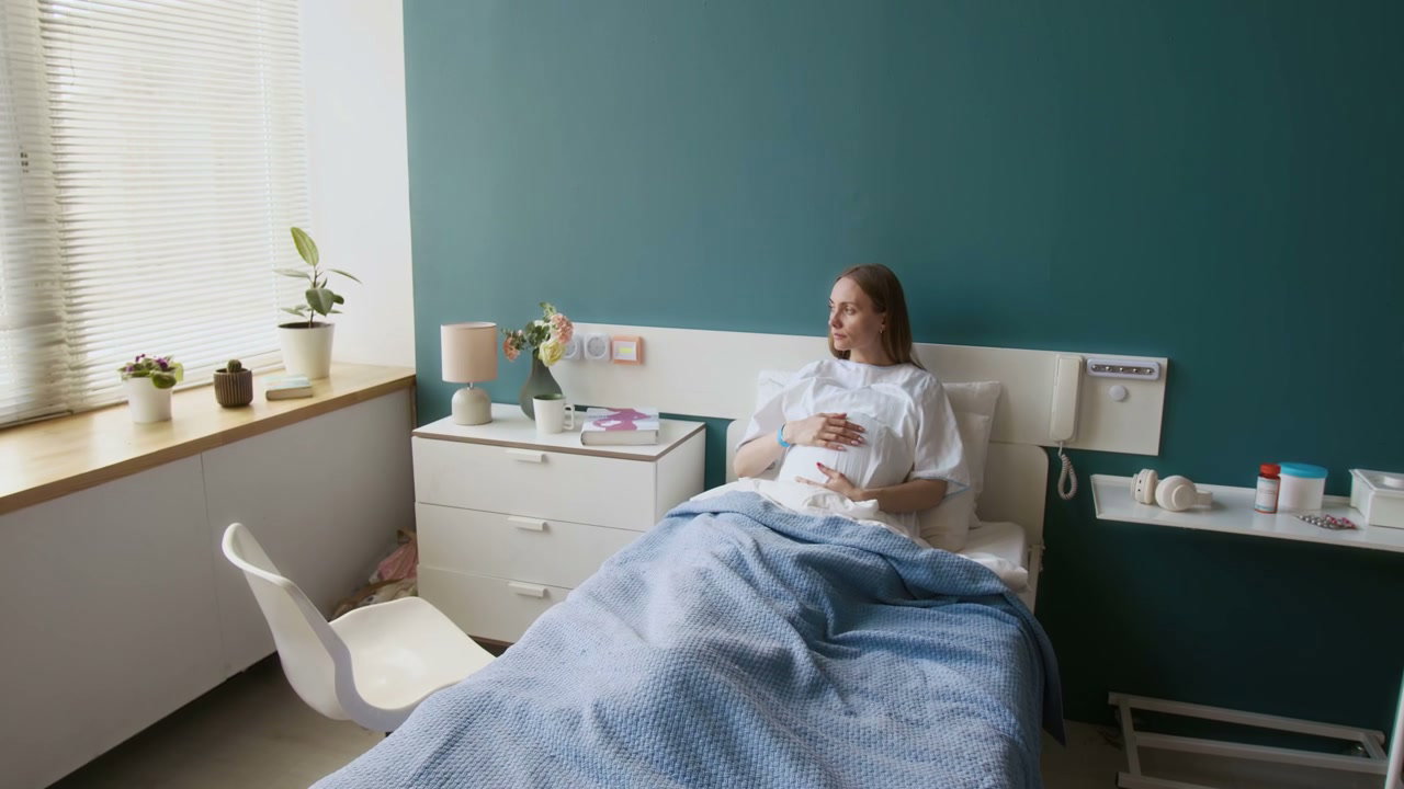 Pregnant Woman Contemplating in Hospital Bed