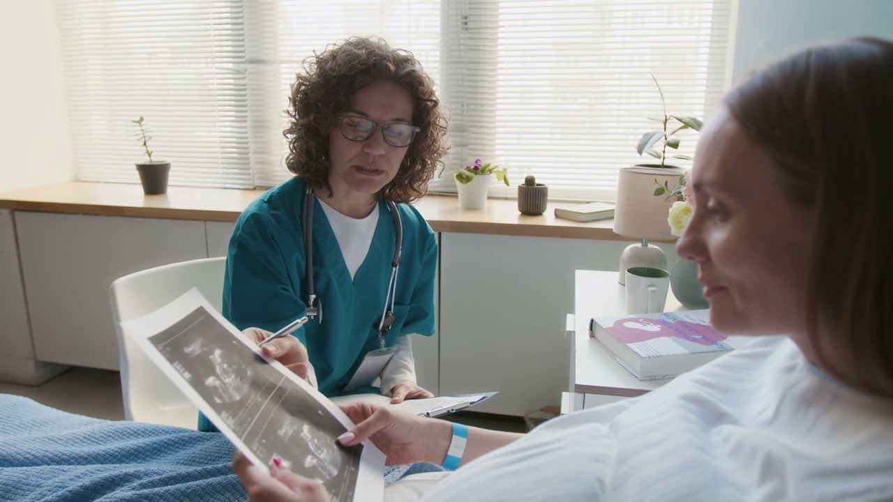 Doctor Explaining Ultrasound to Pregnant Woman