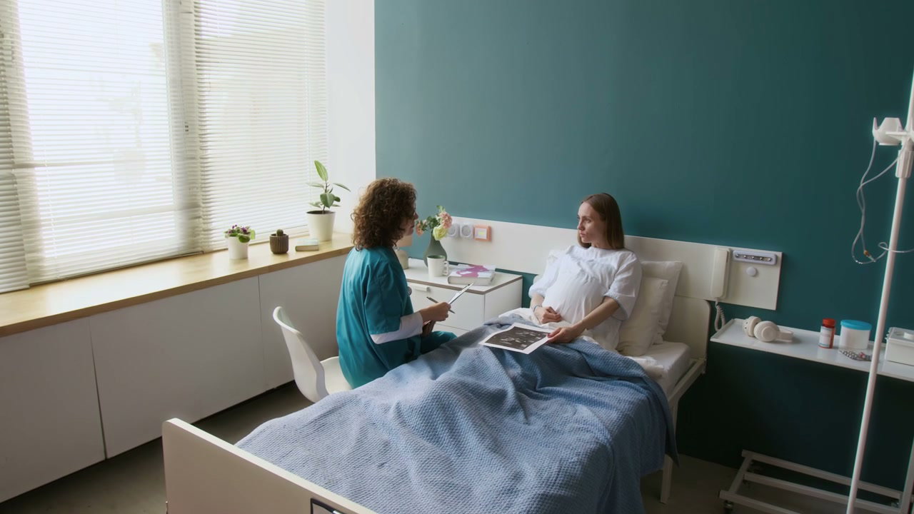Pregnant Woman and Doctor Discuss Ultrasound