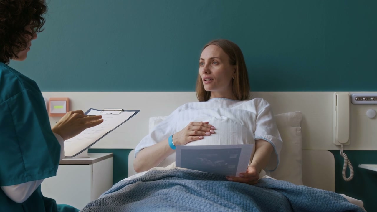 Pregnant Woman Discussing Ultrasound with Doctor