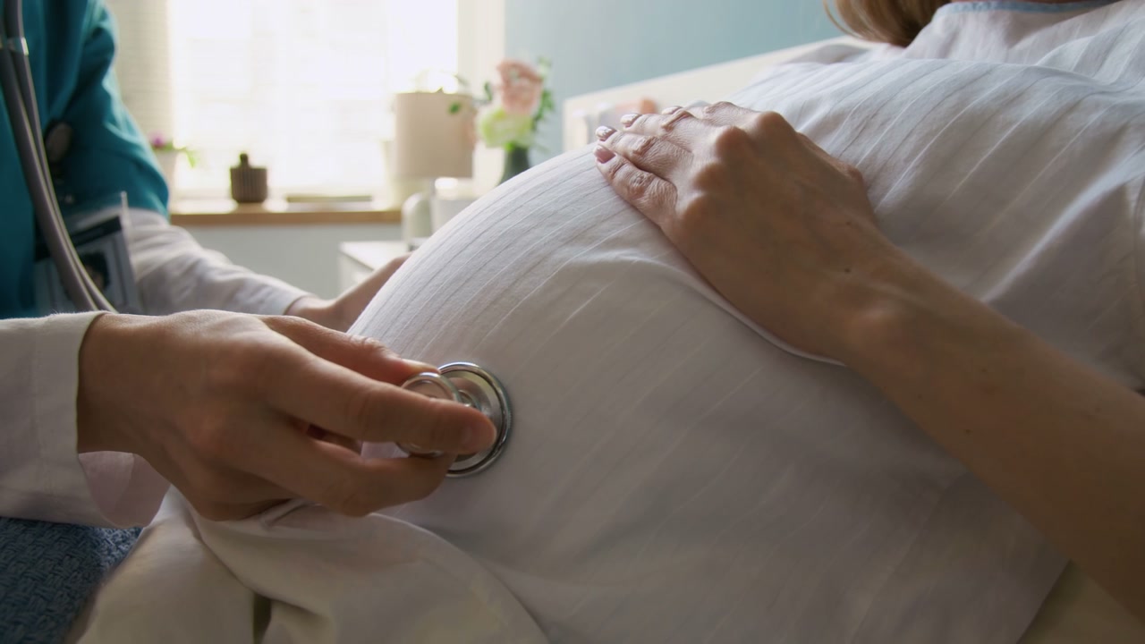 Doctor Checks Pregnant Woman's Belly