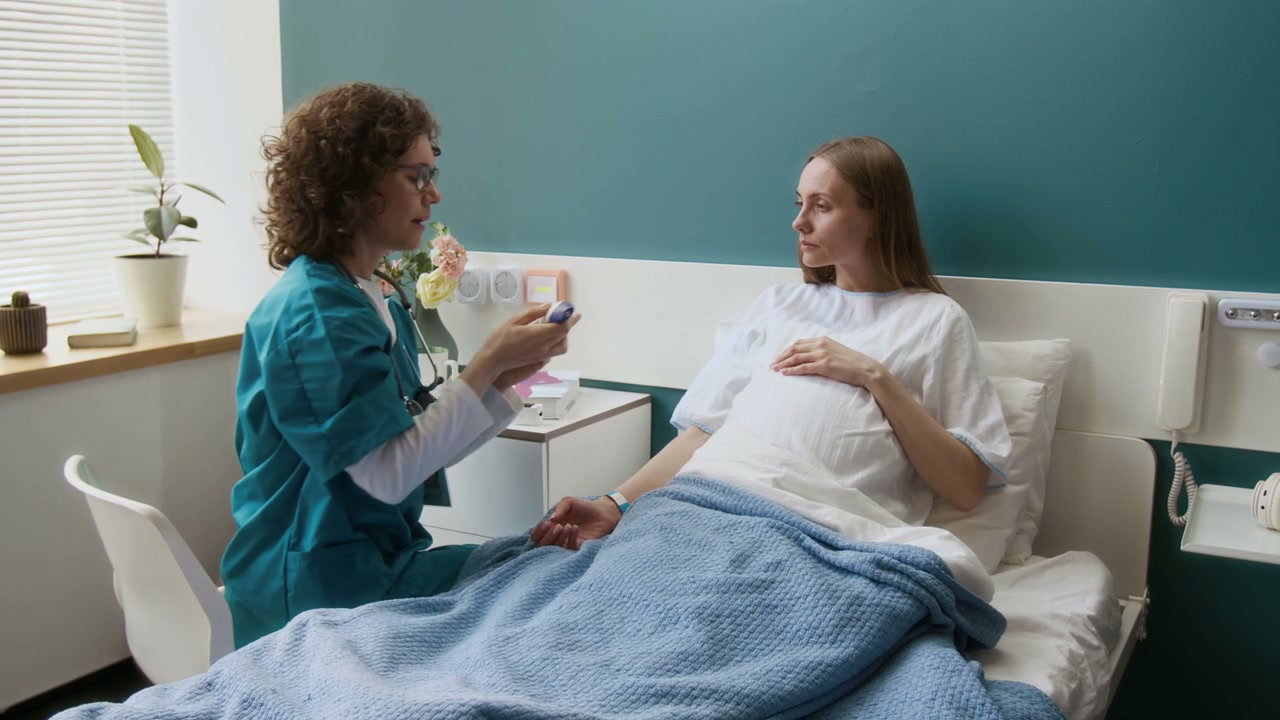 Doctor Measures Pregnant Woman's Temperature