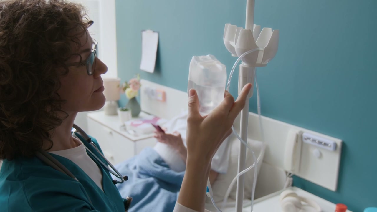 Nurse Attaching IV Drip in Maternity Ward