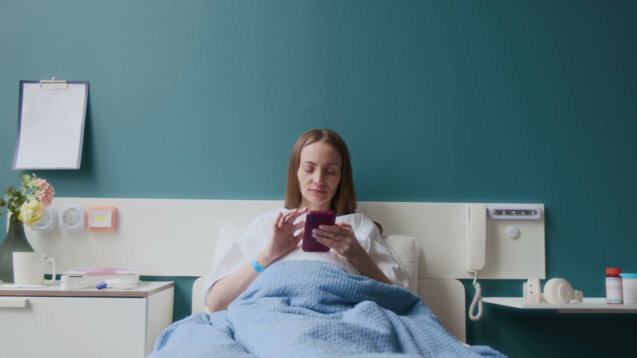 Woman Using Smartphone in Hospital Bed