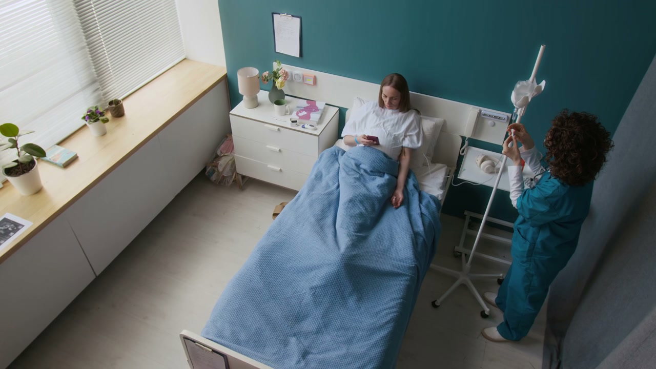 Nurse Adjusts IV Drip for Pregnant Patient