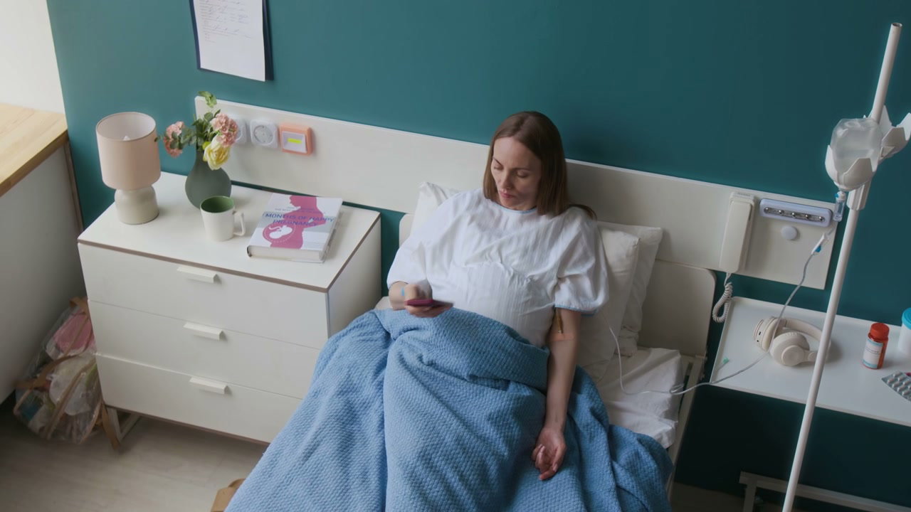 Patient Using Smartphone in Hospital Bed