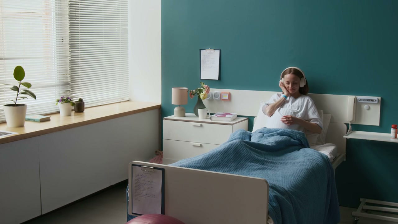 Pregnant Woman Listening to Music in Maternity Ward