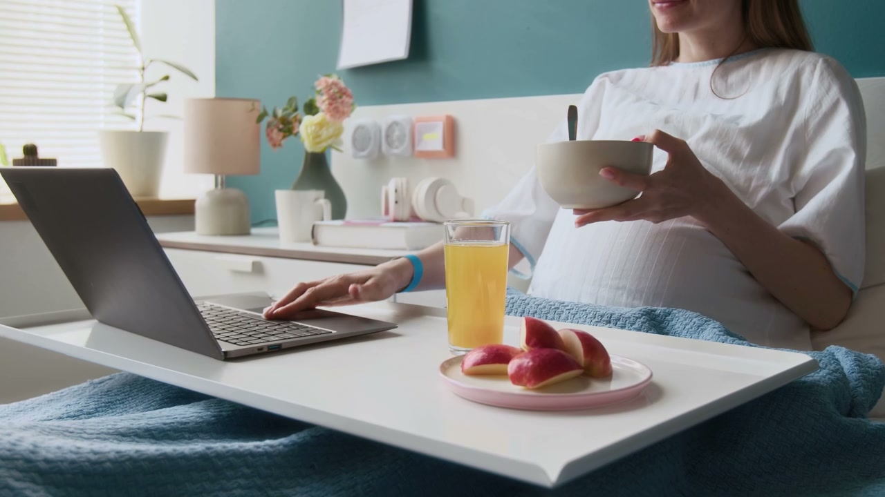 Pregnant Woman Eating Breakfast in Hospital