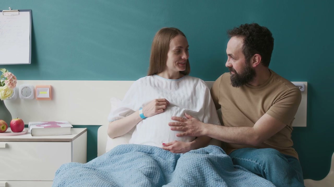 Pregnant Woman and Partner in Hospital Room