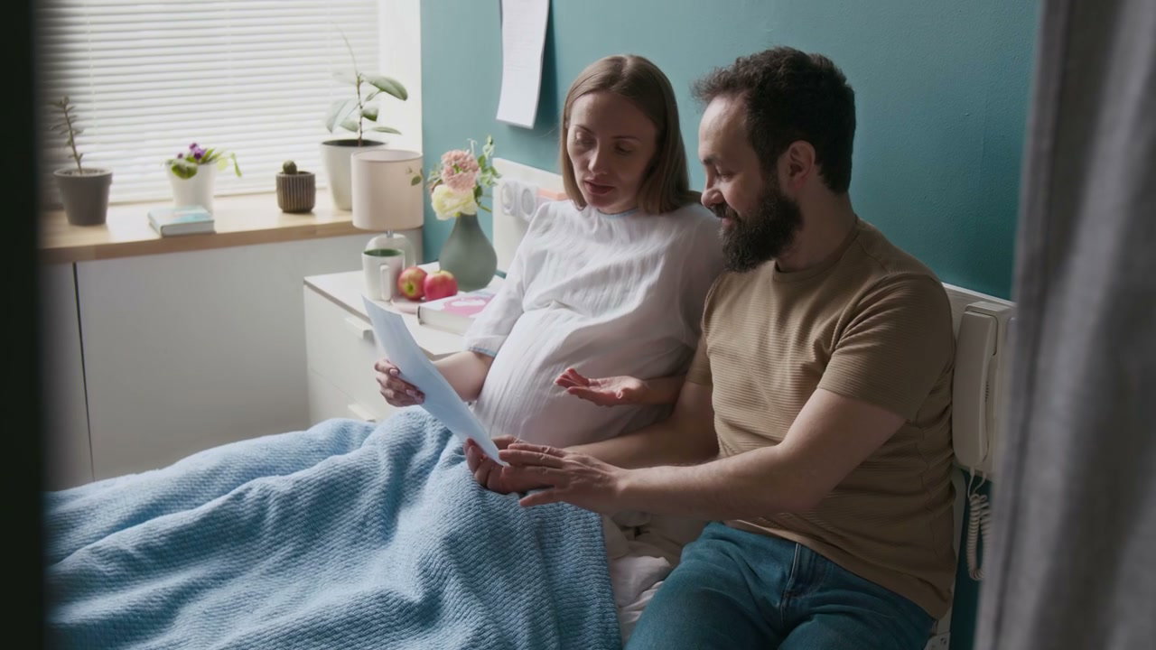 Pregnant Couple Reviewing Ultrasound Images