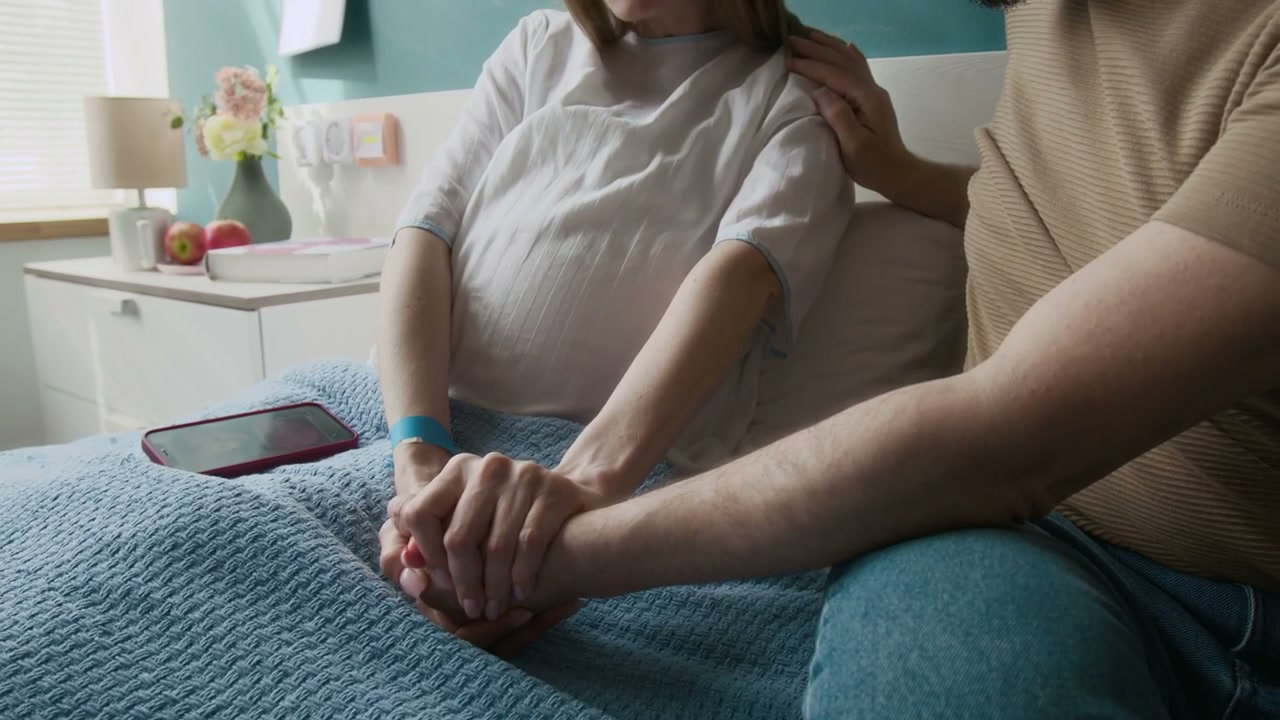 Partner Comforts Pregnant Woman During Contractions