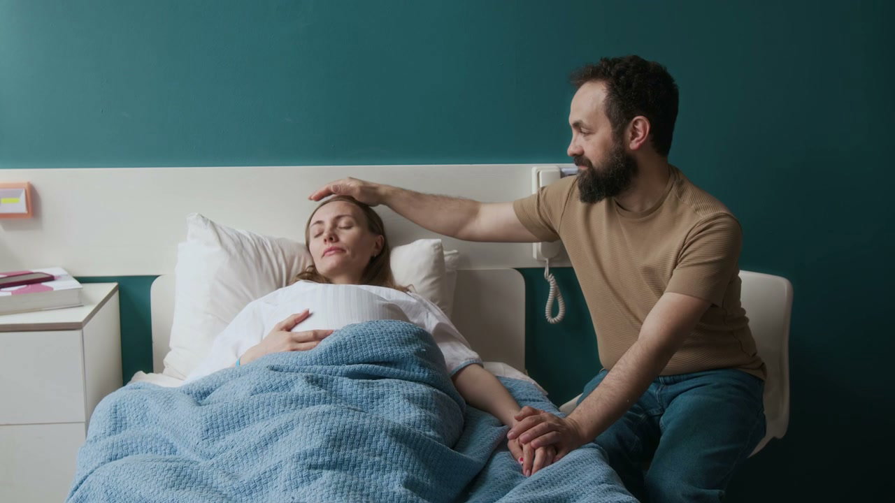 Partner Comforts Pregnant Woman in Hospital