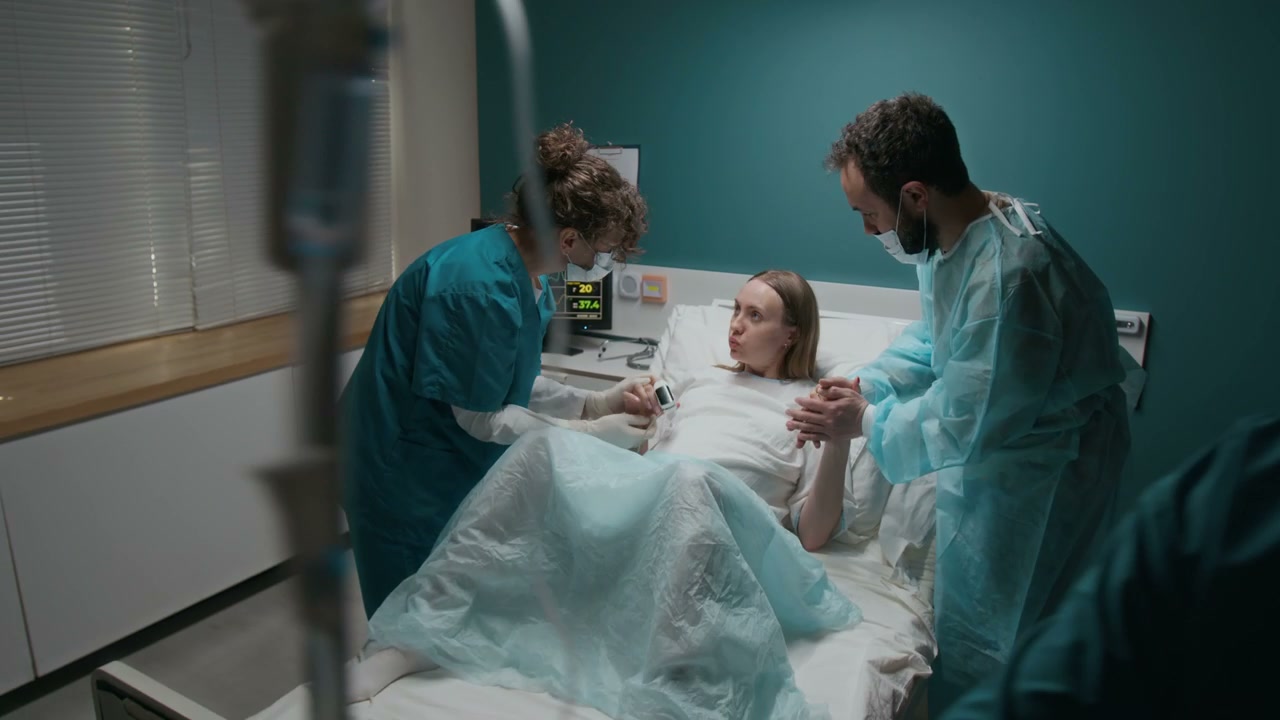 Pregnant Woman in Labor with Partner and Nurse