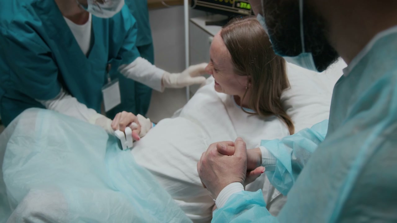 Woman in Labor Supported by Partner and Nurse