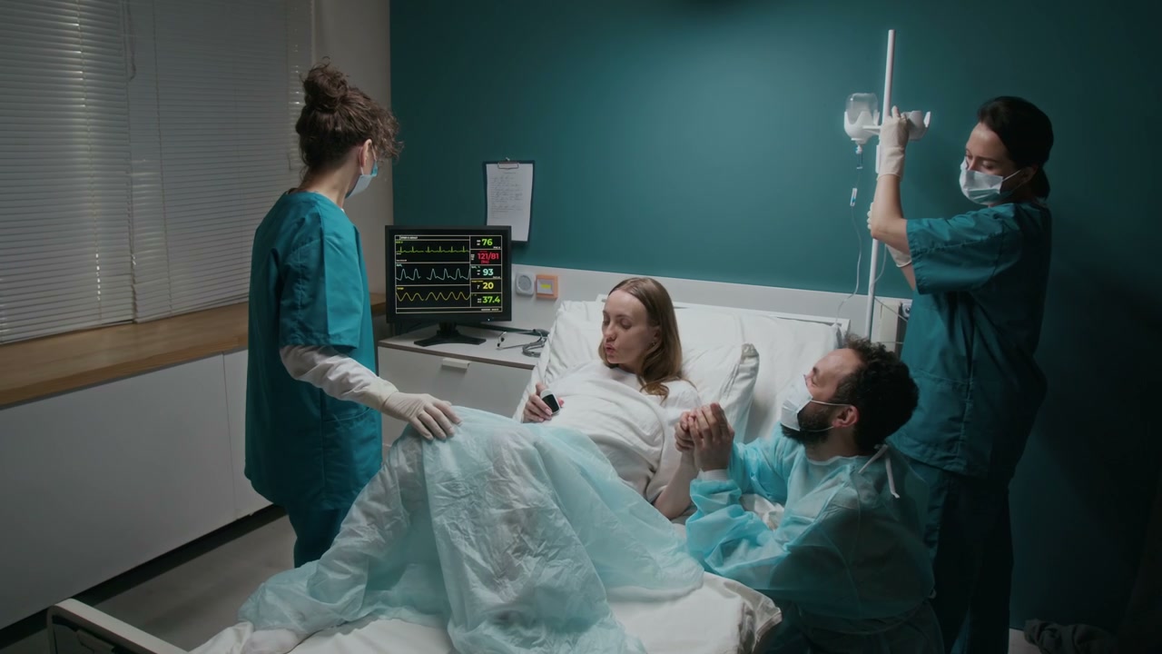 Pregnant Woman in Labor with Partner and Nurses