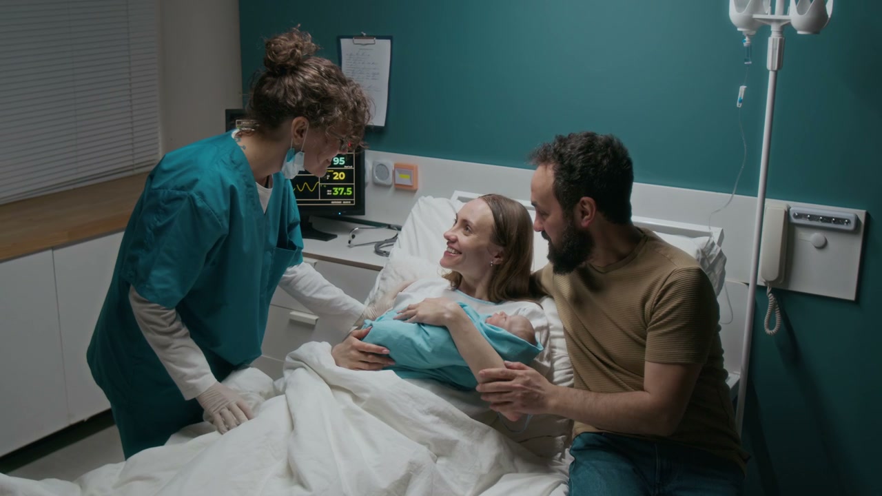 New Parents with Baby and Midwife