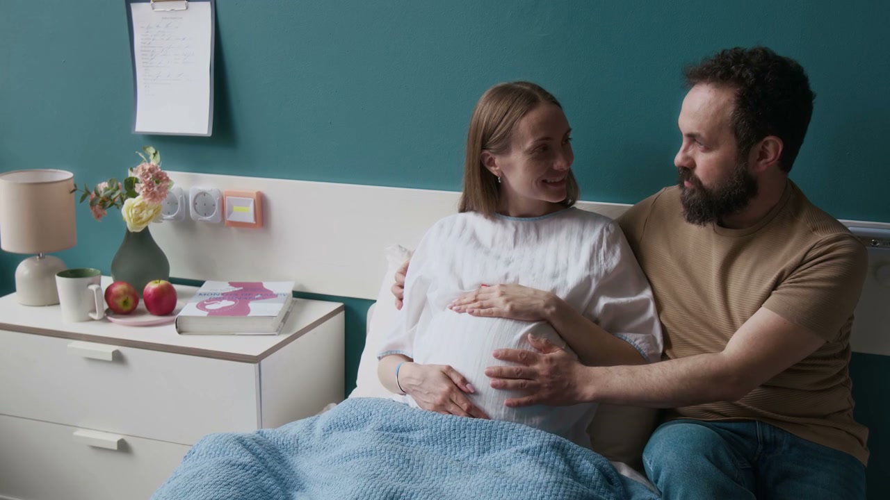 Pregnant Couple Talking in Hospital Room