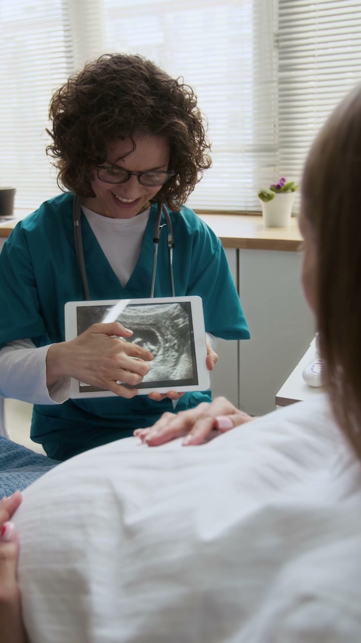 Doctor Explains Ultrasound to Pregnant Woman