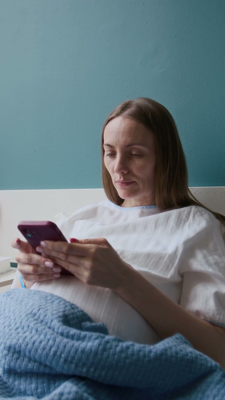 Pregnant Woman Using Smartphone on Hospital Bed
