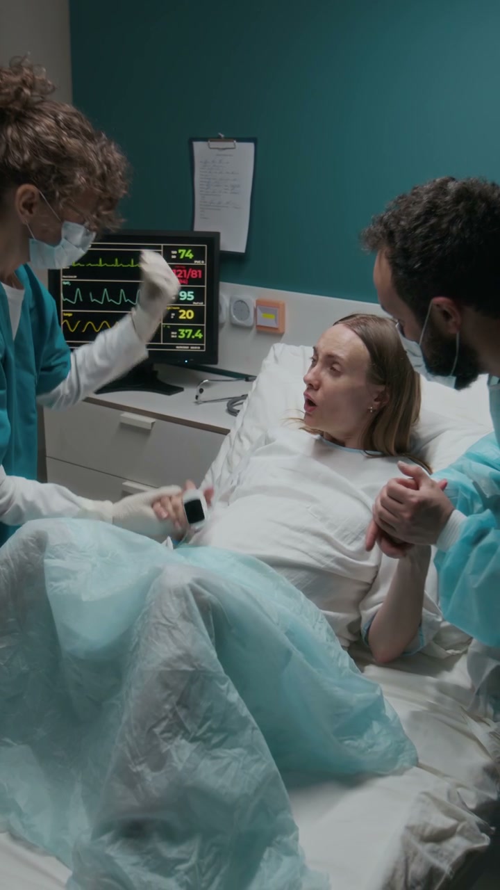Woman in Labor Supported by Partner and Nurse
