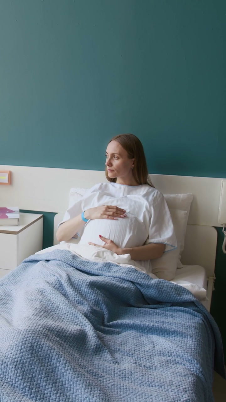 Pregnant Woman Contemplating in Hospital Bed