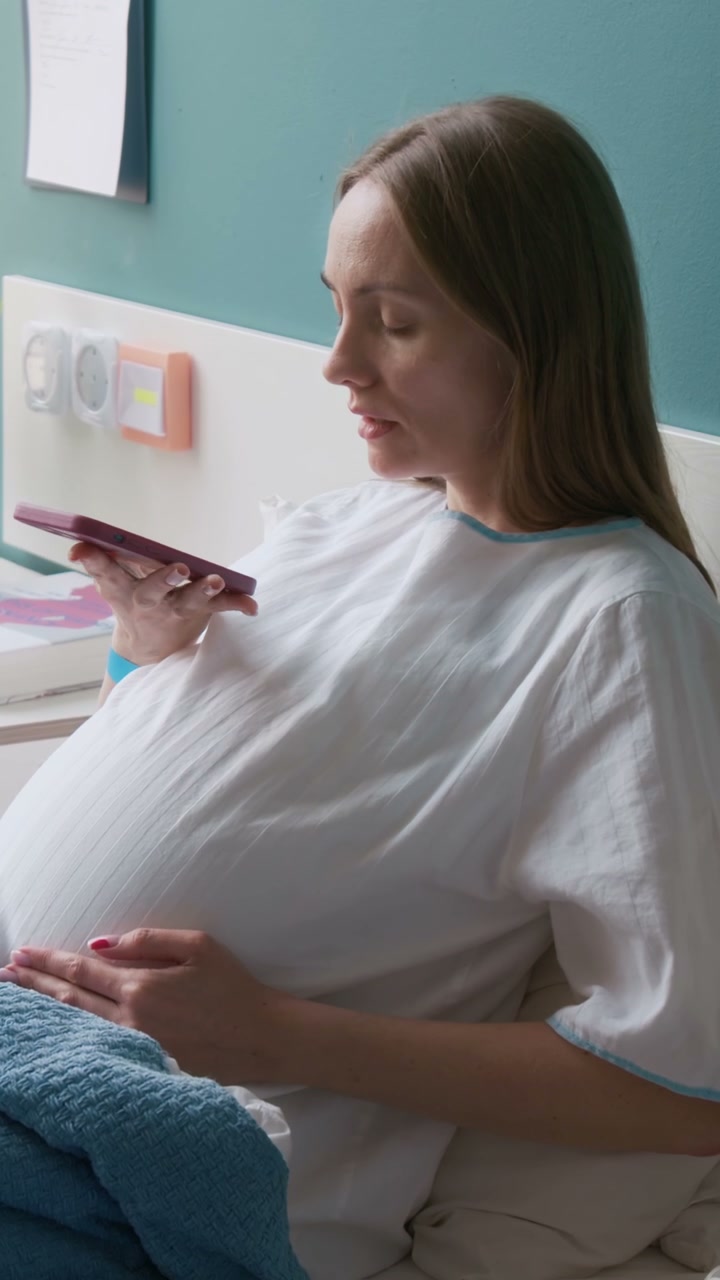 Pregnant Woman Sending Voice Message in Hospital