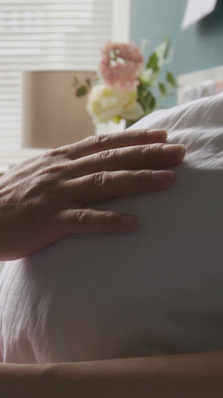 Hand Gently Caressing Pregnant Belly