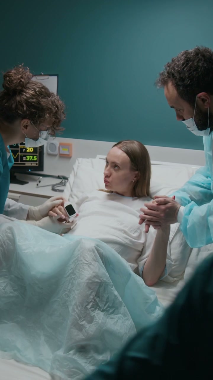Pregnant Woman in Labor with Partner and Nurse