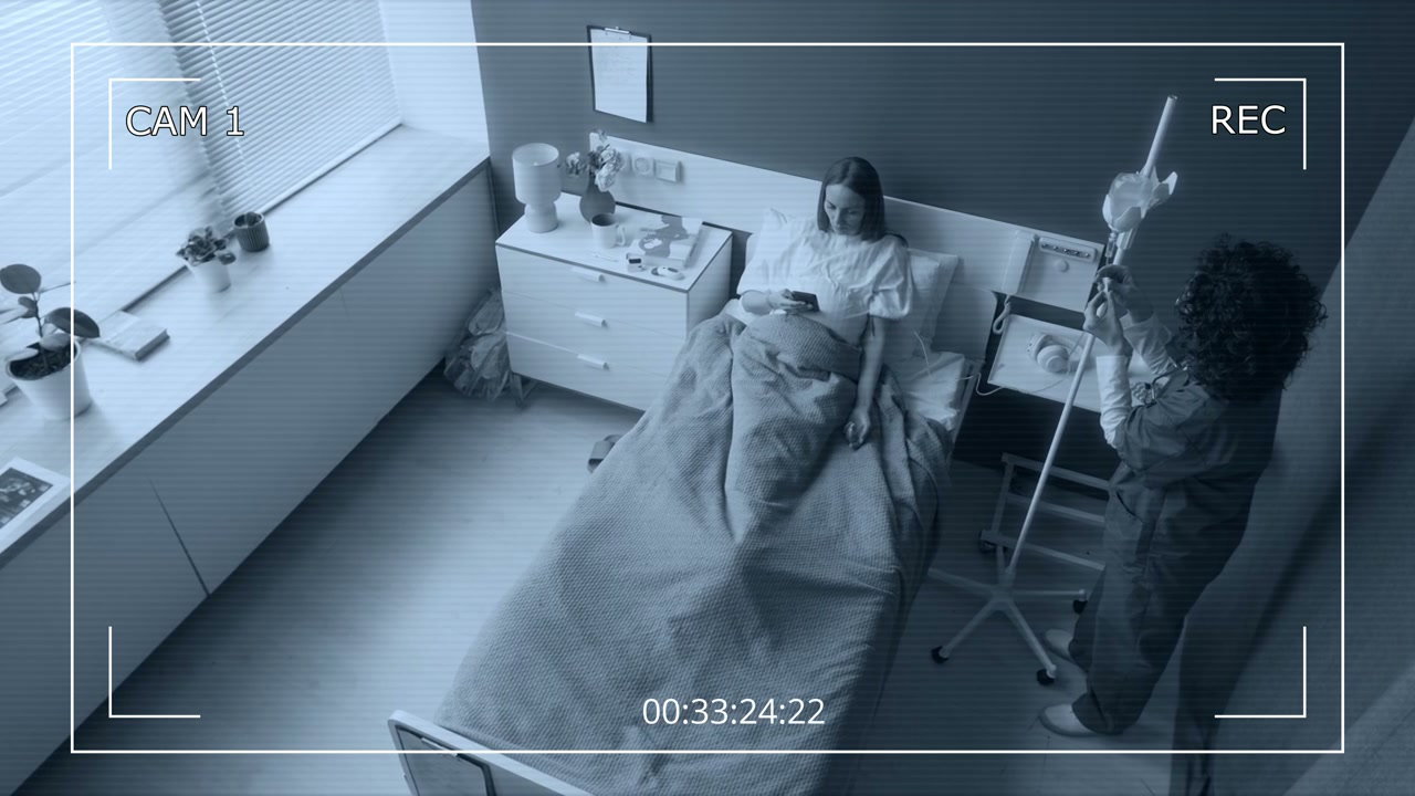 Nurse and Patient in Hospital Room CCTV View