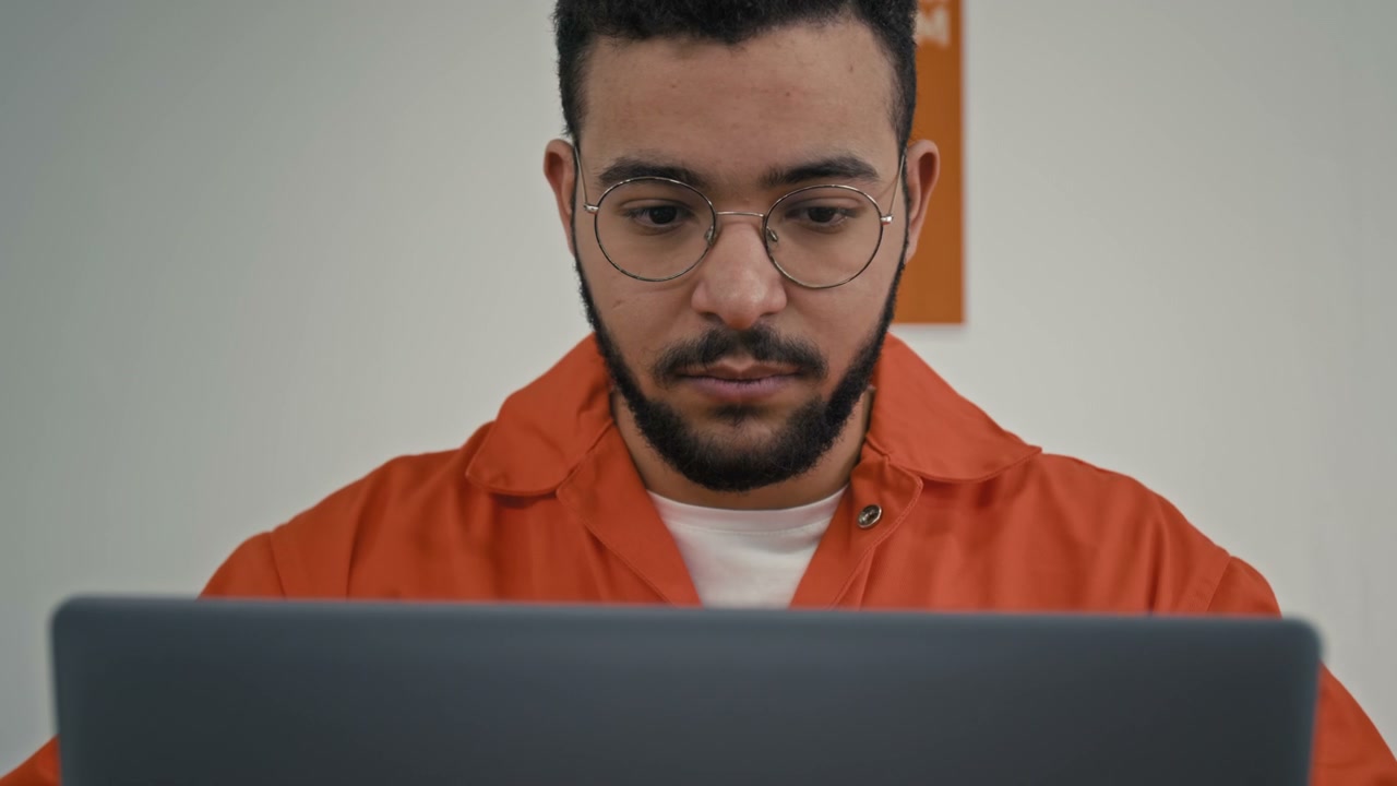 Prison Inmate Studying on Laptop