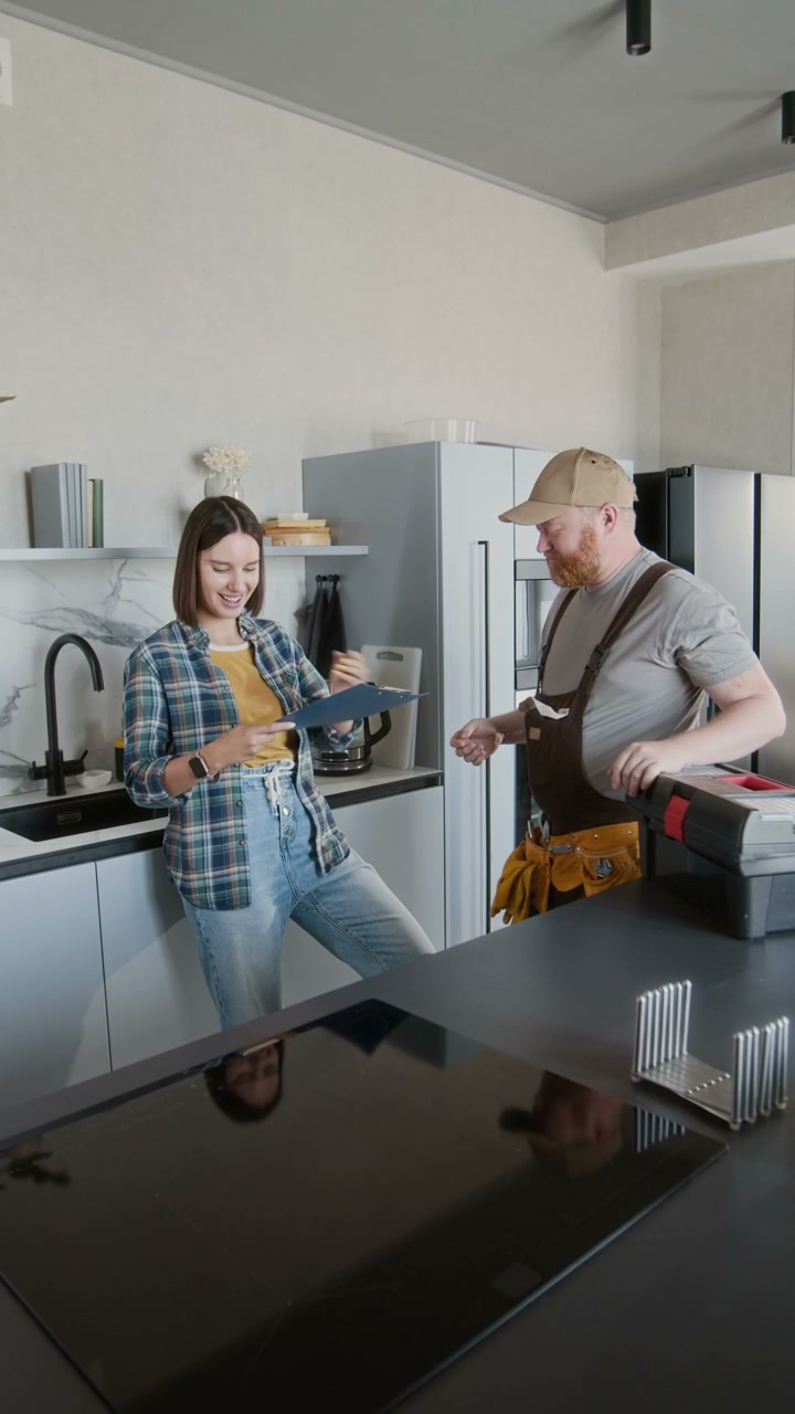 Client Signs Document and Shakes Hand with Repairman