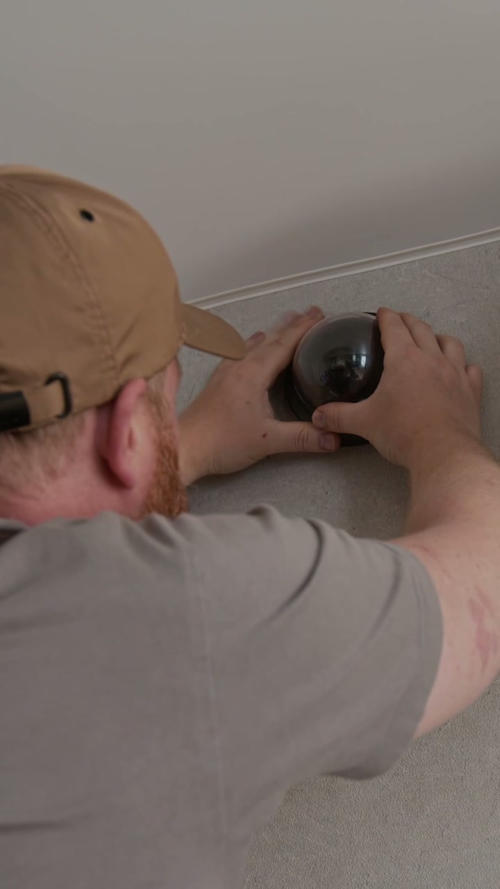 Technician Installing Home Security Camera