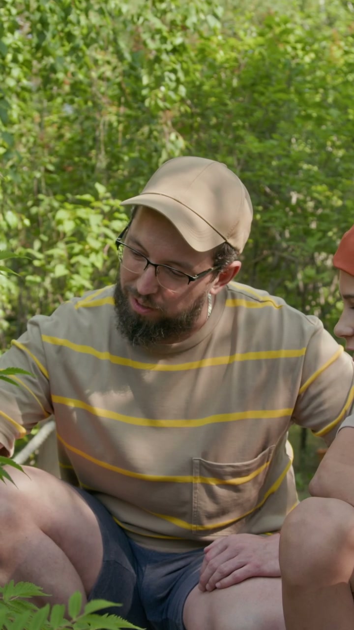 Father and Son Discussing Plants in Garden