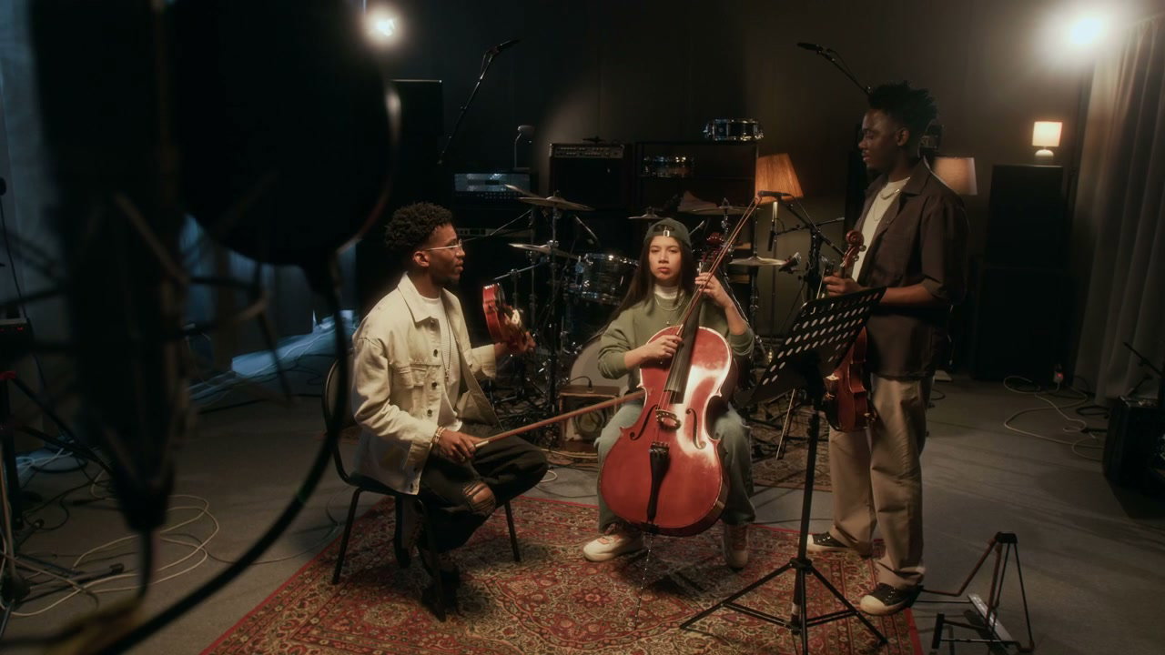 Violin and Cello Trio Playing Music in Studio
