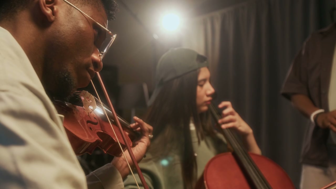 Diverse Group Playing String Instruments in Studio