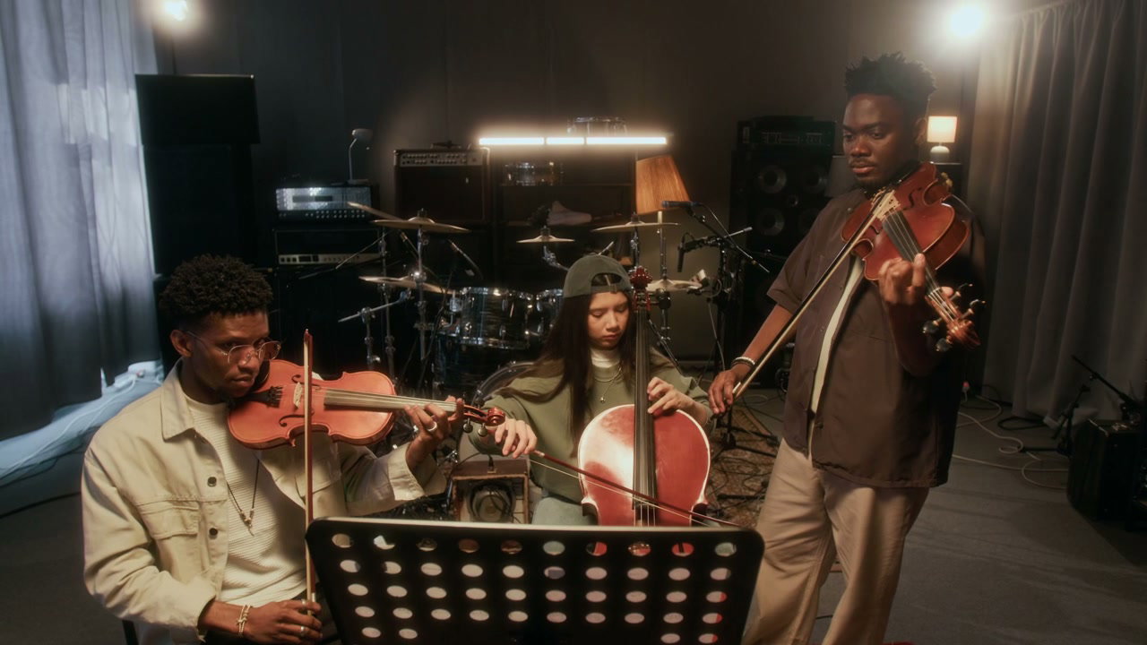 Music Trio Playing Violins and Cello in Studio