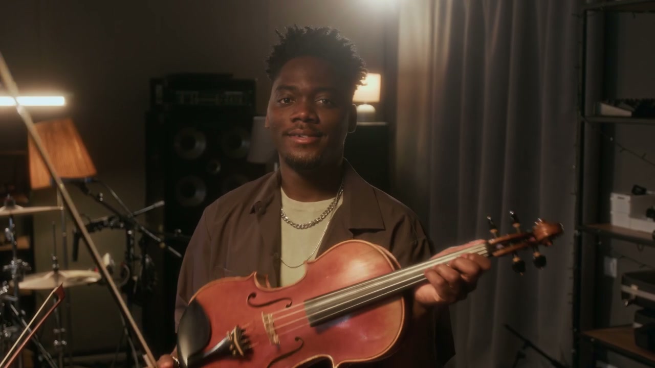 Smiling Musician Holding Violin in Studio