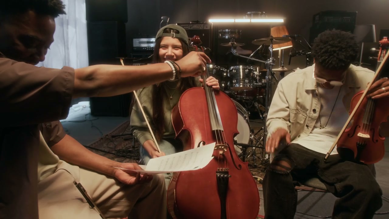 Musicians Discussing Sheet Music in Studio