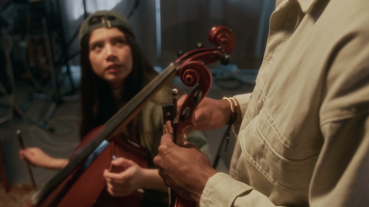Musician Tuning Violin in Music Studio
