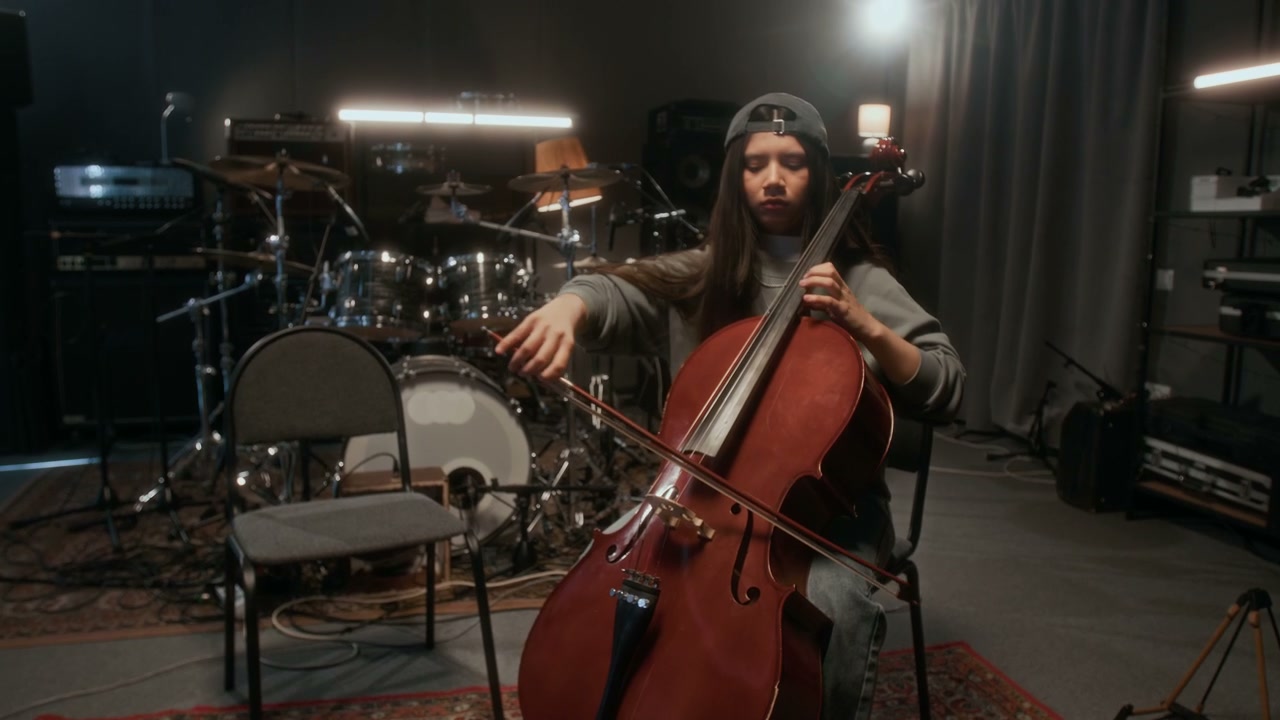 Female Cellist Playing in Music Studio