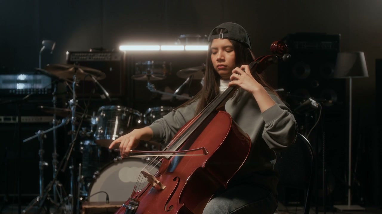 Woman Playing Cello in a Music Studio