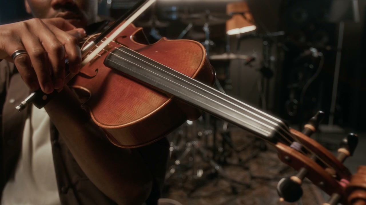Man Playing Violin in Music Studio